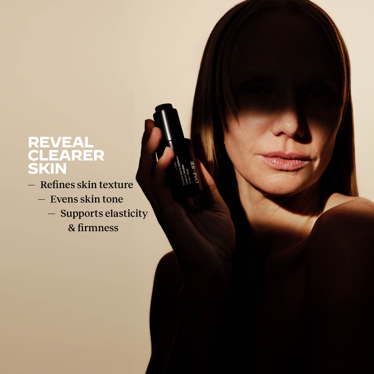 Woman holding an OM-SE Balancing Face Oil with skin benefits text: Reveals clear skin, Refines skin texture, Even skin tone, Supports elasticity and firmness. 