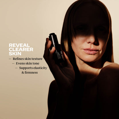 Woman holding an OM-SE Balancing Face Oil with skin benefits text: Reveals clear skin, Refines skin texture, Even skin tone, Supports elasticity and firmness. 