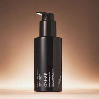 OM-SE Face Cleansing Oil bottle with pump on a gradient brown background